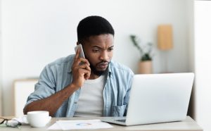 Millennial guy dialing technical support cause his internet is down