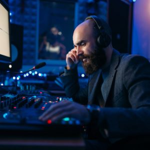 Sound engineer in headphones listens composition